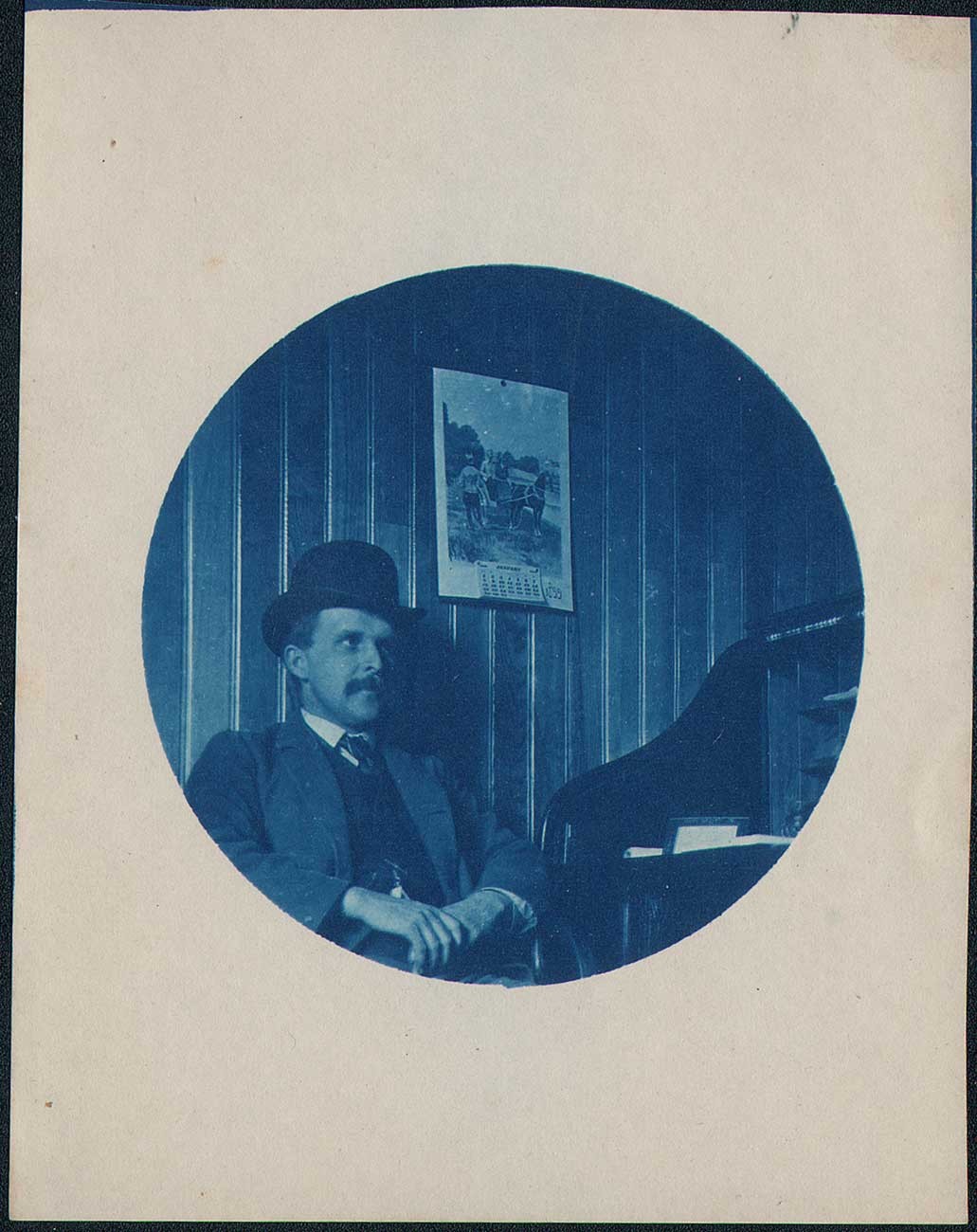 Man with Bowler hat at Desk