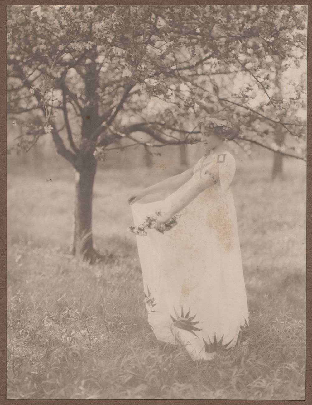 Model under Blossoming Apple Tree