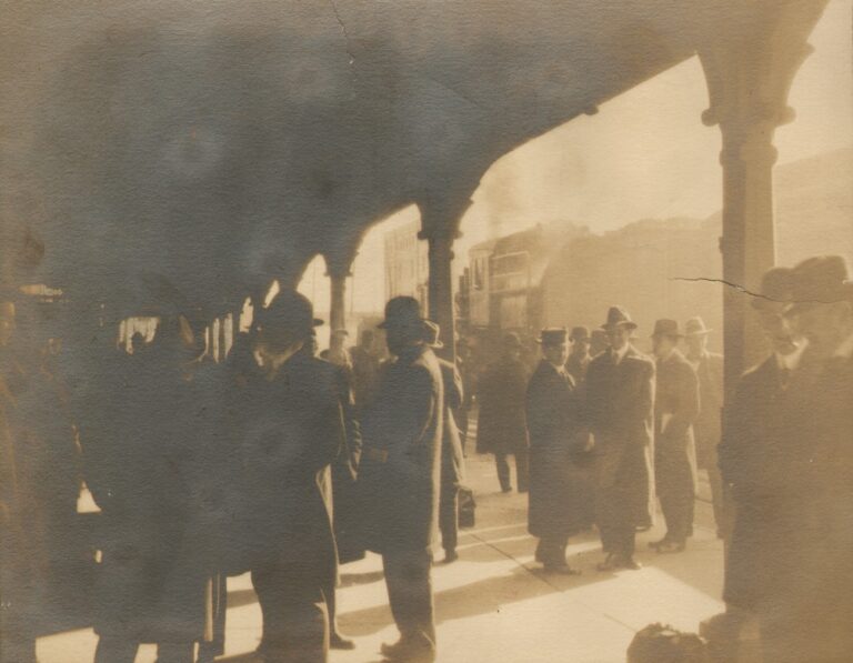Men Waiting on Train Station Platform