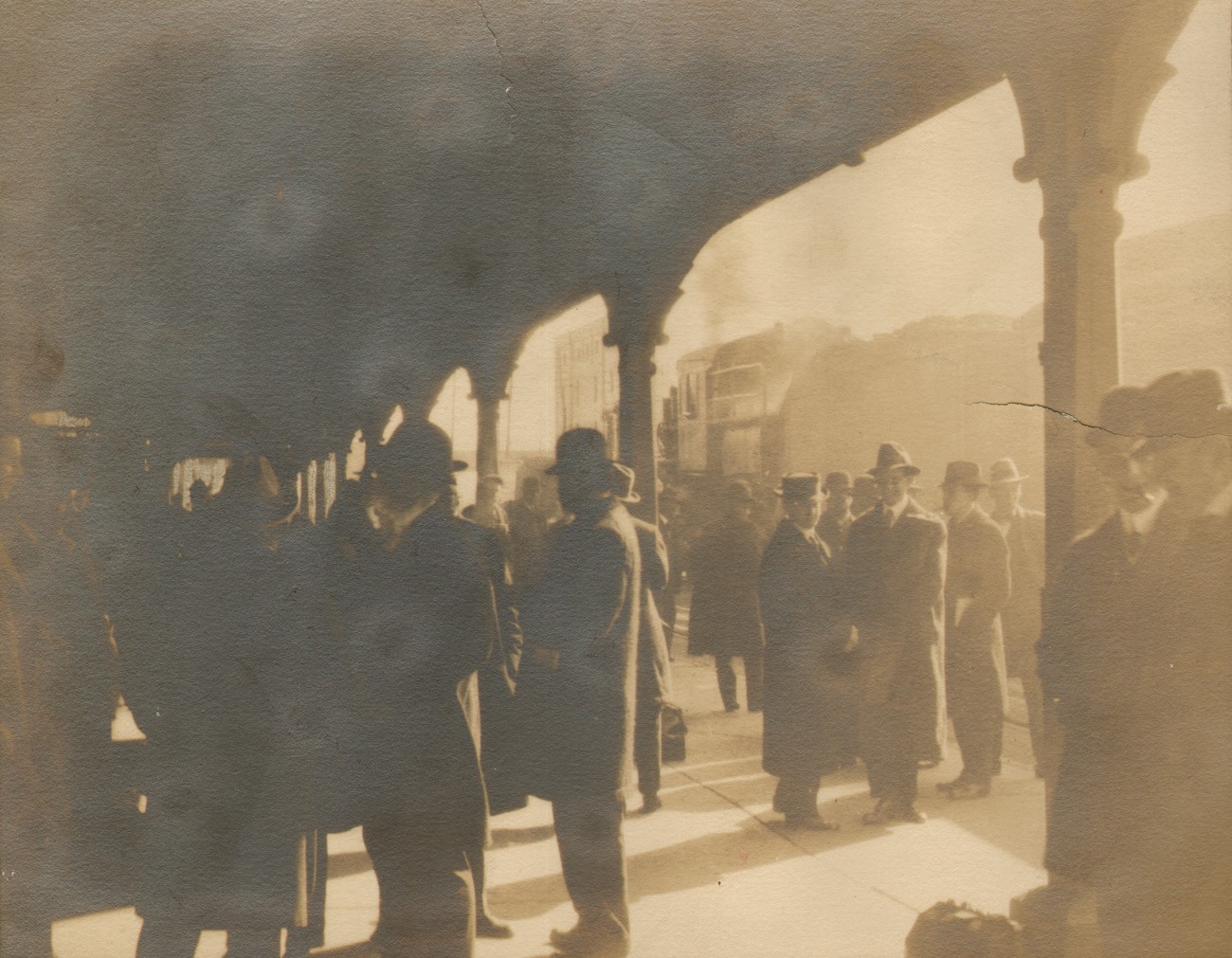 Men Waiting on Train Station Platform