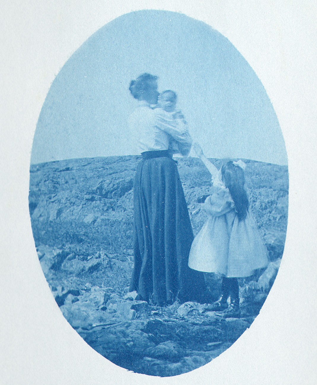 Child reaches for woman holding Baby