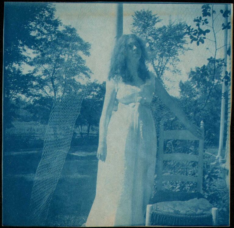 Woman in White Dress Standing next to Chair